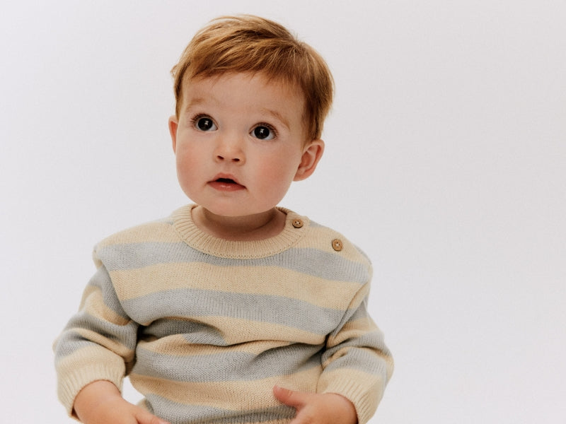 baby with striped cardigan